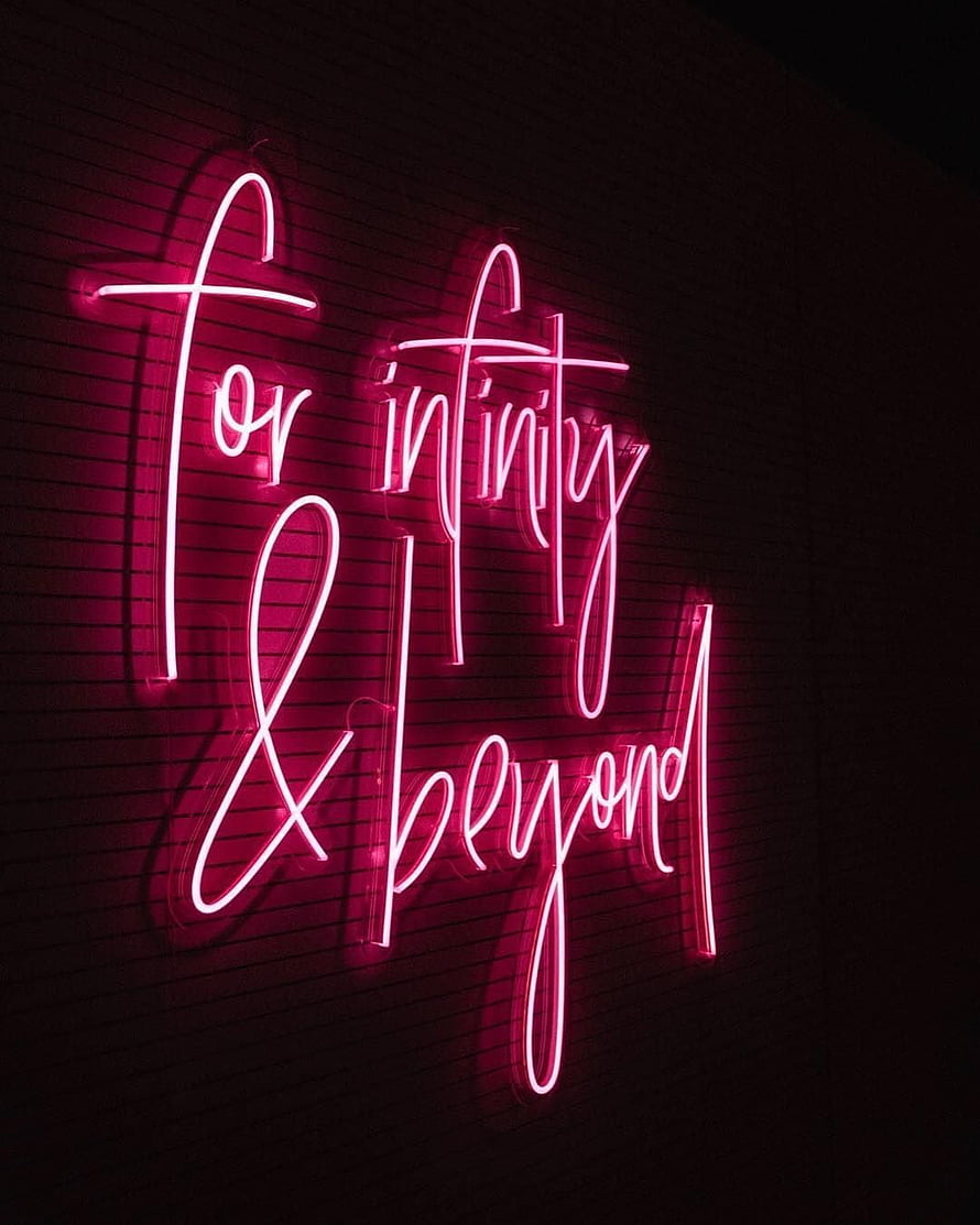 Pink Cursive Neon Sign Reading For Infinity And Beyond On Dark Brick Wall HD phone wallpaper