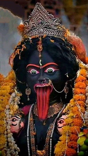 Maa Kali Deity Portrait with Ornate Crown and Marigold Garland HD phone wallpaper
