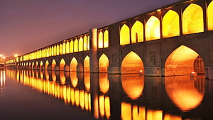 Si-o-se Pol Bridge in Isfahan, Iran, illuminated at night with golden arches reflected in the Zayandeh River HD wallpaper
