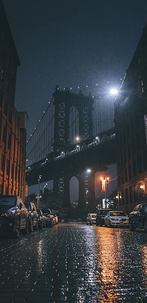 Manhattan Bridge at Night Over Wet Cobblestone Street in New York City HD phone wallpaper