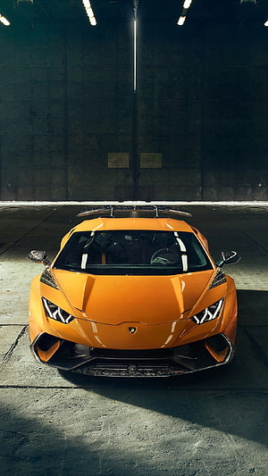 Orange Lamborghini Huracán Front View in Industrial Garage Setting HD phone wallpaper