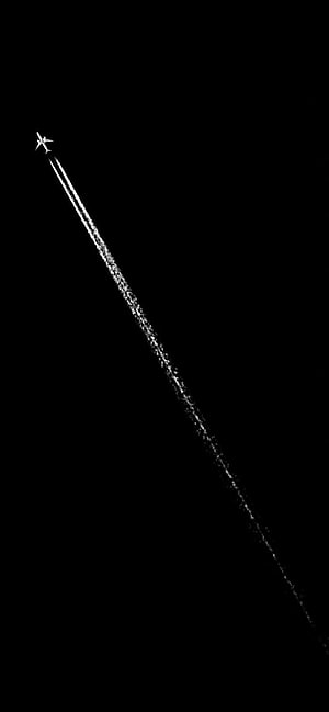 Minimalist airplane contrail against a stark black sky HD phone wallpaper