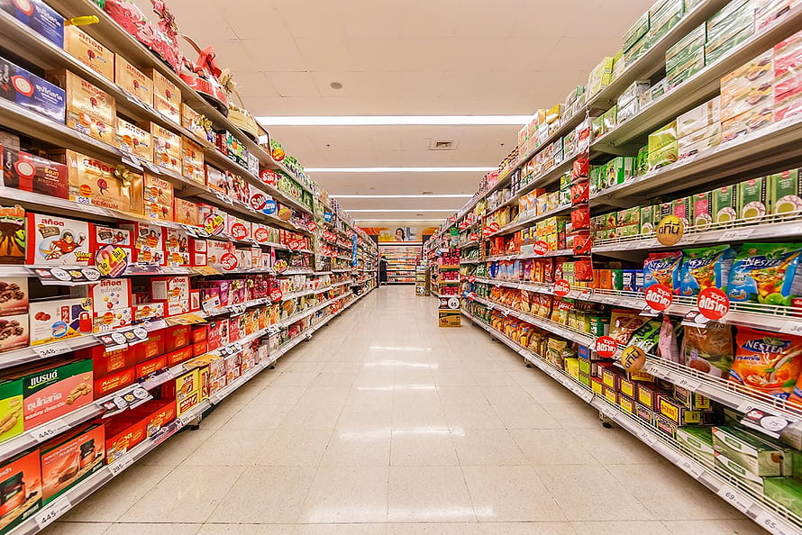 Brightly Lit Supermarket Aisle Packed With Colorful Grocery Products HD wallpaper