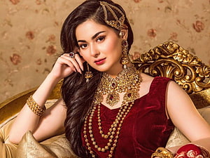 Hania Amir in Traditional Red Velvet Attire with Ornate Gold Jewelry and Headpiece HD wallpaper
