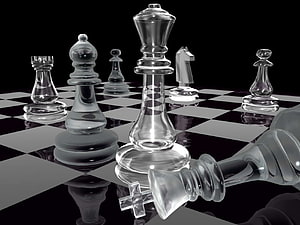 Transparent Glass Chess Pieces on a Reflective Black and White Board HD wallpaper