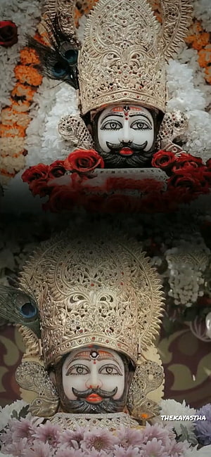 Khatushyam Ji Murti Adorned With Silver Crown, Peacock Feathers, And Fresh Floral Garlands HD phone wallpaper