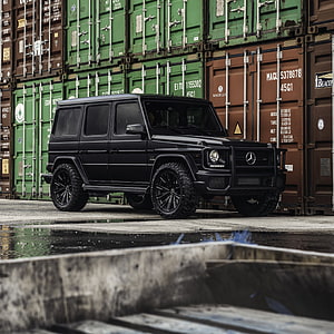 Black Mercedes G63 AMG SUV Parked in Front of Stacked Shipping Containers HD phone wallpaper