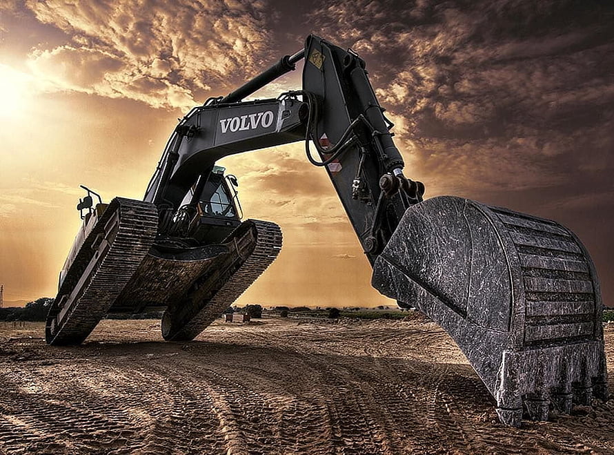 Volvo Heavy Excavator at Sunset in a Construction Site HD wallpaper