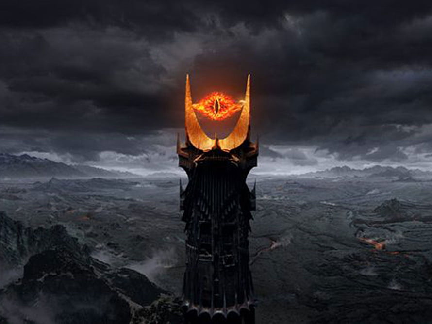 The Eye of Sauron Tower Rising Over a Dark Volcanic Landscape HD wallpaper