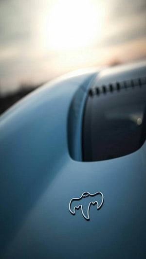 Koenigsegg Ghost Hypercar Close-Up with Ghost Emblem on Matte Blue Bodywork HD phone wallpaper