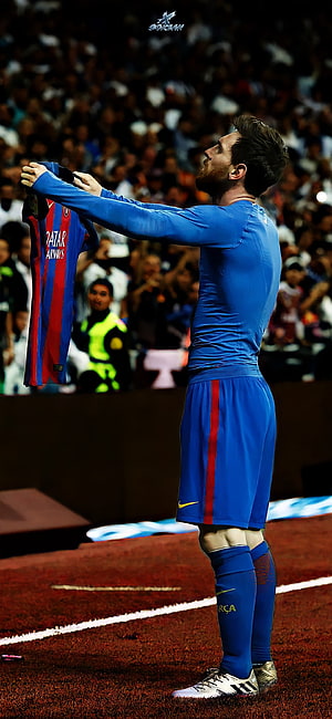 Lionel Messi in Barcelona Kit Holding PSG Jersey on the Pitch HD phone wallpaper