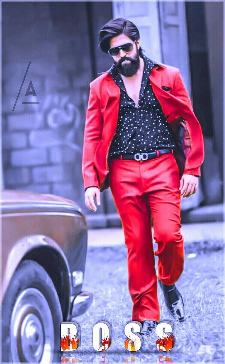 Yash as Rocky Bhai in KGF wearing a bold red suit and sunglasses HD phone wallpaper