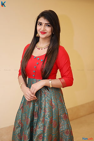 Sreeleela in a red blouse and teal brocade lehenga with gold jewelry HD phone wallpaper