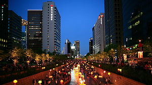 Cheonggyecheon Stream at Dusk in Seoul with Glowing Lanterns and City Skyline HD wallpaper