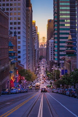 San Francisco Chinatown Street View with Cable Car and Bay Bridge at Sunset HD phone wallpaper