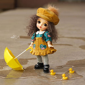 Cute BJD Doll in Yellow Corduroy Outfit with Umbrella and Rubber Ducks in Rain Puddle HD phone wallpaper