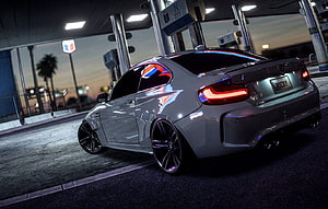 Silver BMW M2 Competition Coupe at a Gas Station at Dusk HD wallpaper