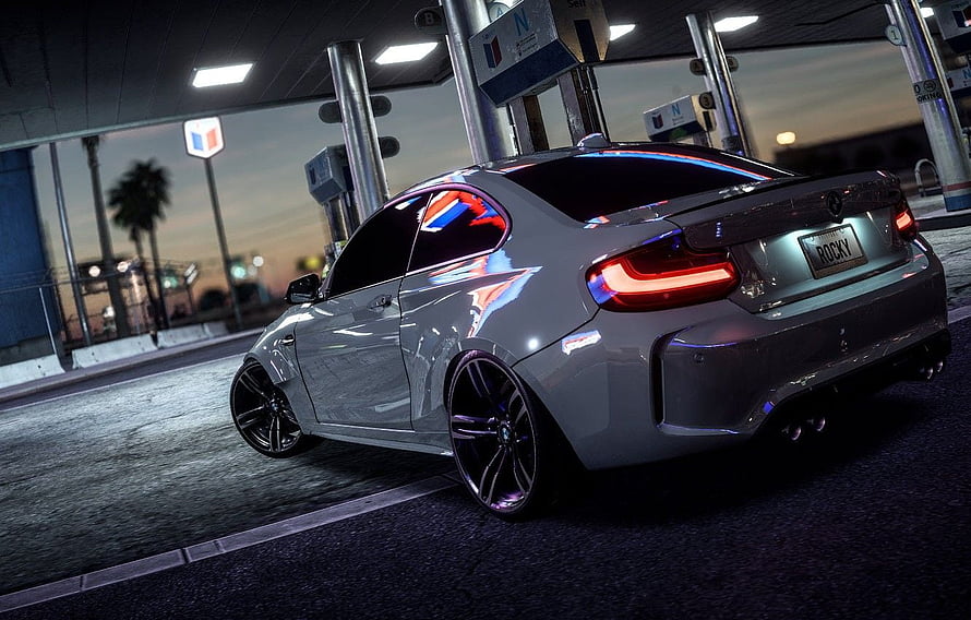 Silver BMW M2 Competition Coupe at a Gas Station at Dusk HD wallpaper