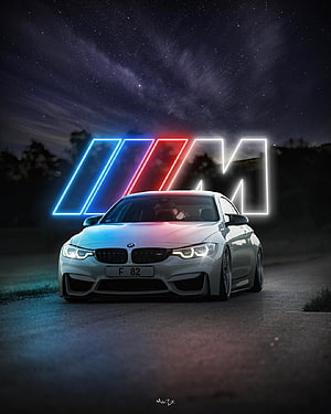 White BMW M4 Coupe with Neon M Logo Under Starry Night Sky HD phone wallpaper