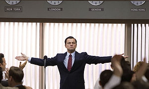 Leonardo DiCaprio as Jordan Belfort in The Wolf of Wall Street with arms spread wide in a trading floor scene HD wallpaper