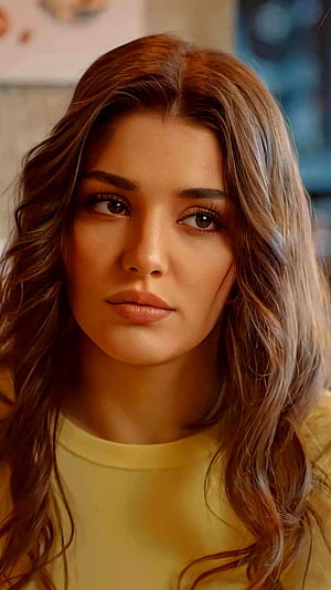 Hande Erçel Close-Up Portrait with Wavy Hair and Warm Yellow Top HD phone wallpaper