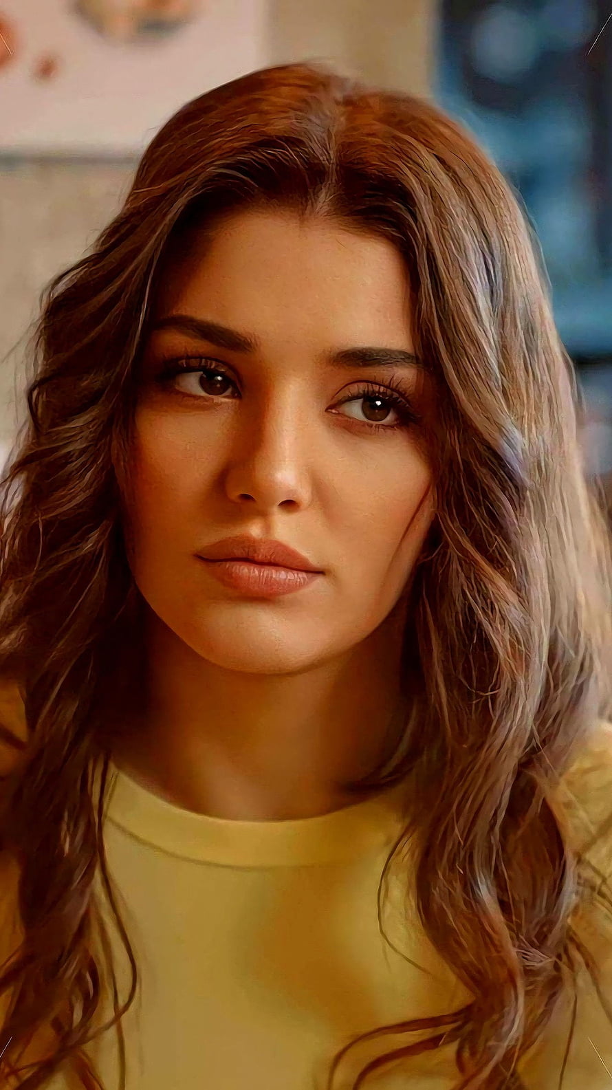 Hande Erçel Close-Up Portrait with Wavy Hair and Warm Yellow Top HD phone wallpaper