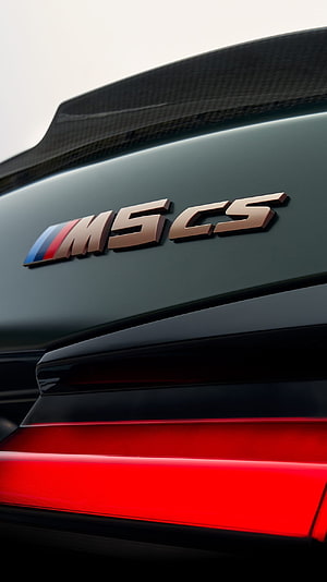 Close-up of BMW M5 CS Rear Badge and Carbon Fiber Spoiler HD phone wallpaper