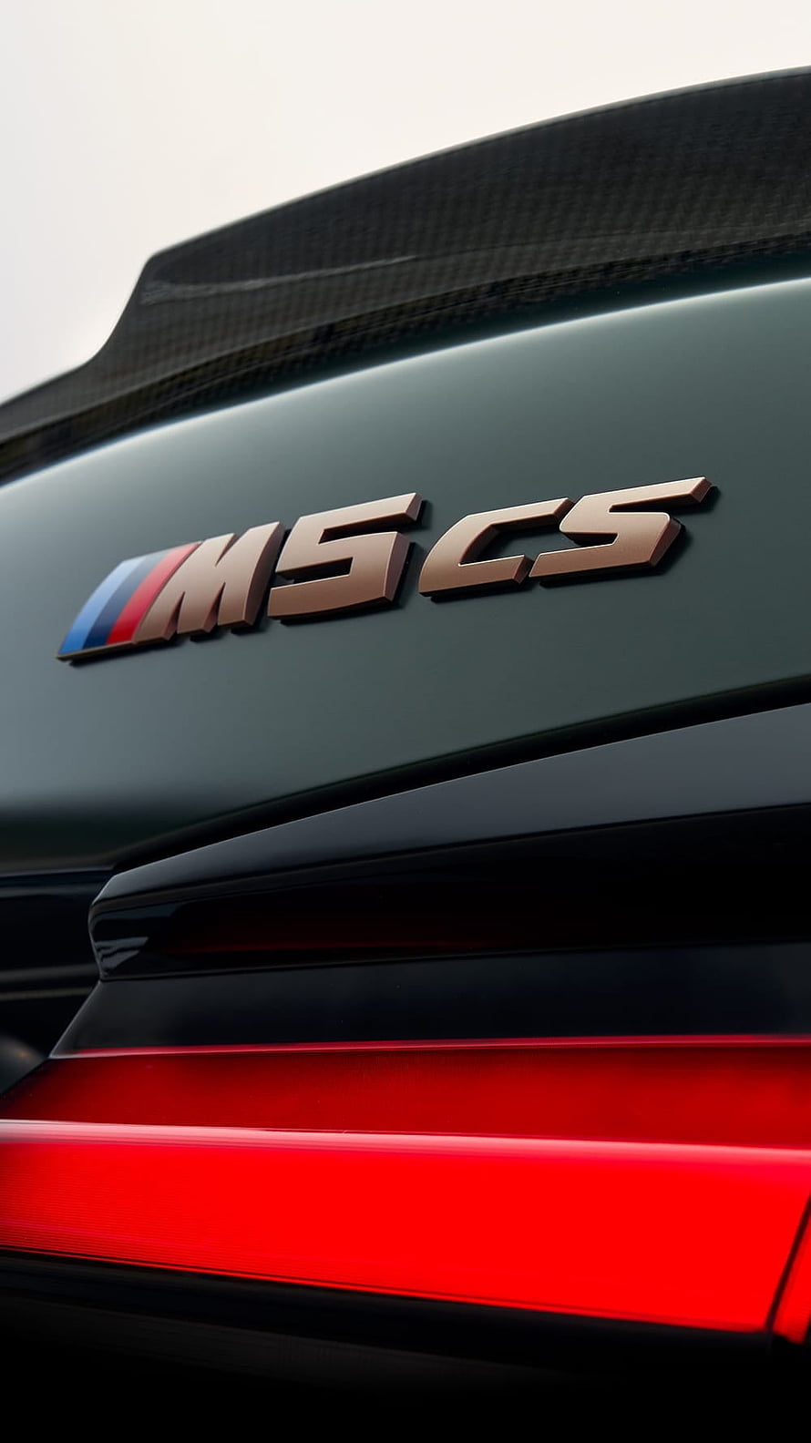 Close-up of BMW M5 CS Rear Badge and Carbon Fiber Spoiler HD phone wallpaper