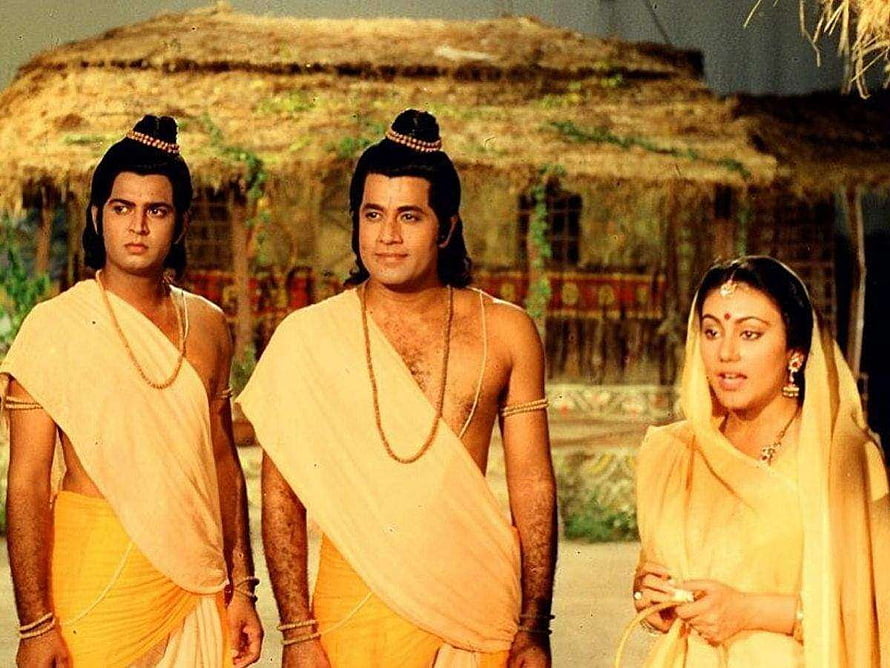 Arun Govil in classic Indian mythological drama with traditional costumes and thatched hut backdrop HD wallpaper