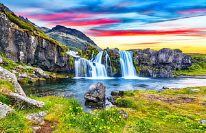 Stjornarfoss Waterfall in Iceland with Vibrant Sunset Sky and Lush Green Meadow HD wallpaper