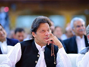 Imran Khan in Black Waistcoat and White Shirt with Prayer Beads at Public Event HD wallpaper