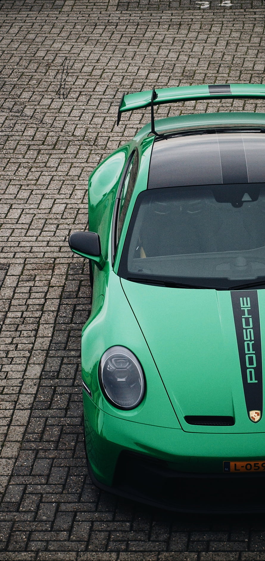Vibrant Green Porsche GT3 RS Front View on Cobblestone Street HD phone wallpaper