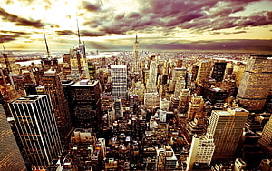 Aerial View of New York City Skyline at Dusk with Dramatic Clouds and Golden Light HD wallpaper