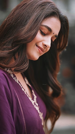 Keerthy Suresh in a purple embroidered kurta with long wavy hair and a gentle smile HD phone wallpaper