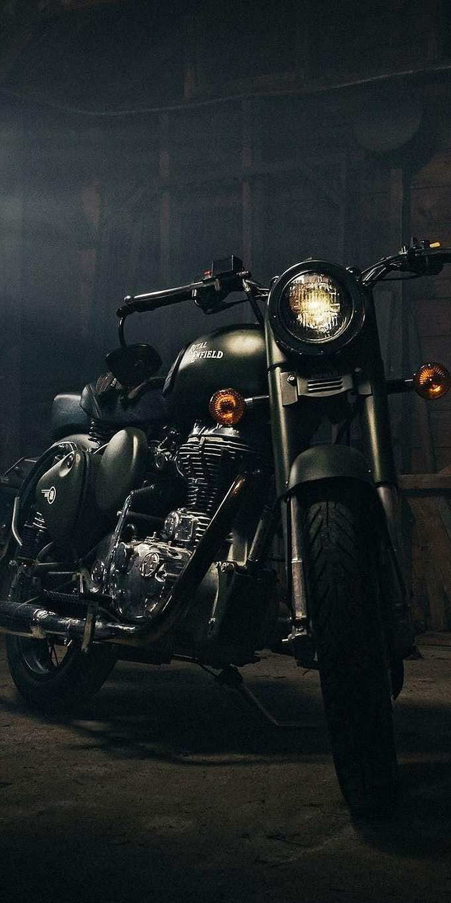 Royal Enfield Bullet Standard motorcycle in a dimly lit garage with dramatic lighting HD phone wallpaper
