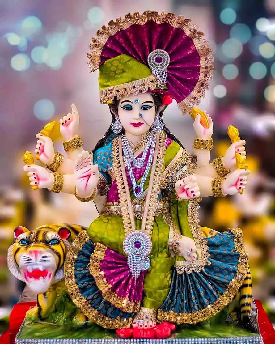 Ornate Durga Puja idol with eight arms, tiger mount, and festive jewelry HD phone wallpaper