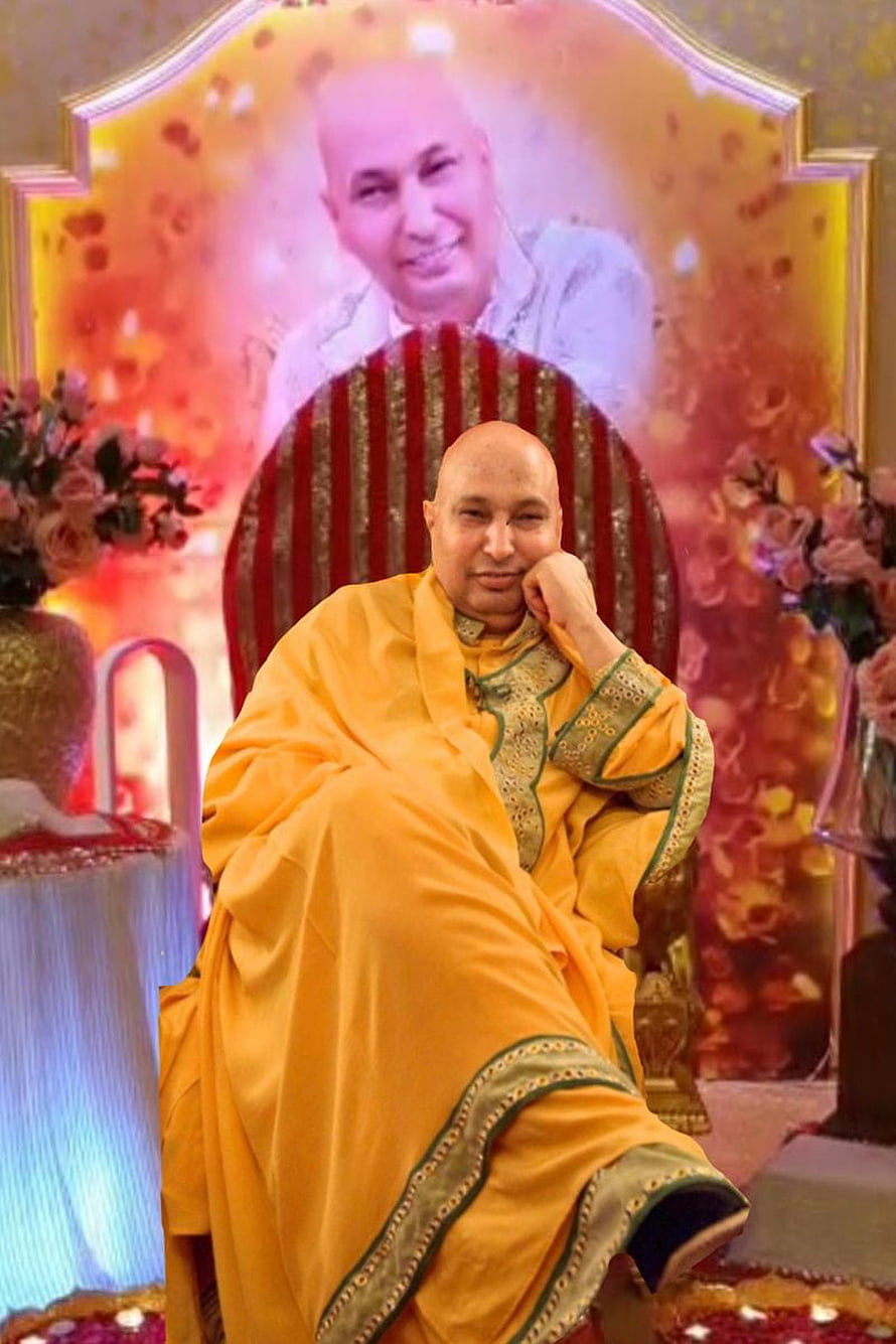Bald spiritual leader in saffron robes seated on ornate throne with floral backdrop HD phone wallpaper