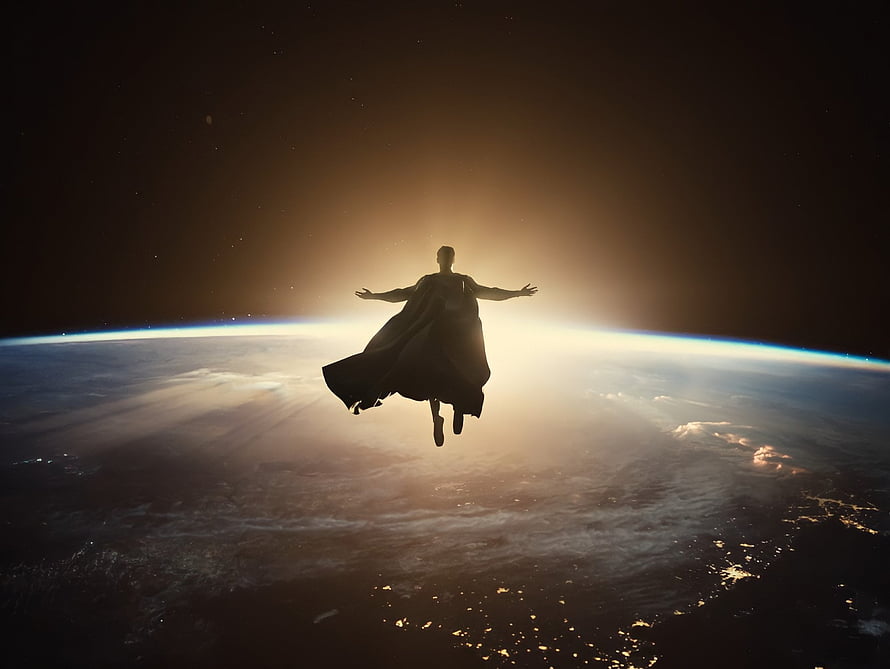 Superman Silhouette Floating Above Earth at Sunrise in Space HD wallpaper