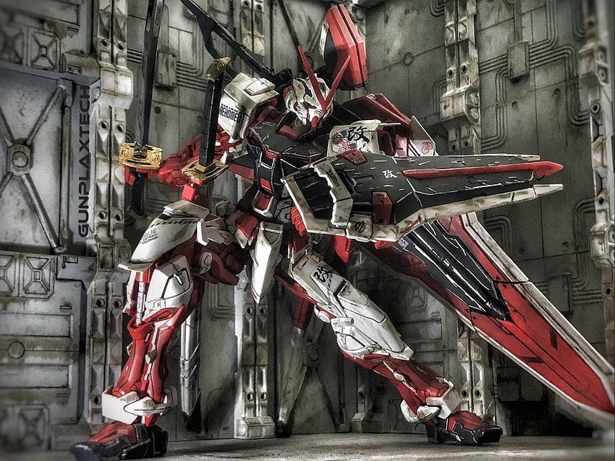 Gundam Astray Red Frame Kai Model with Beam Saber and Shield in Industrial Setting HD wallpaper