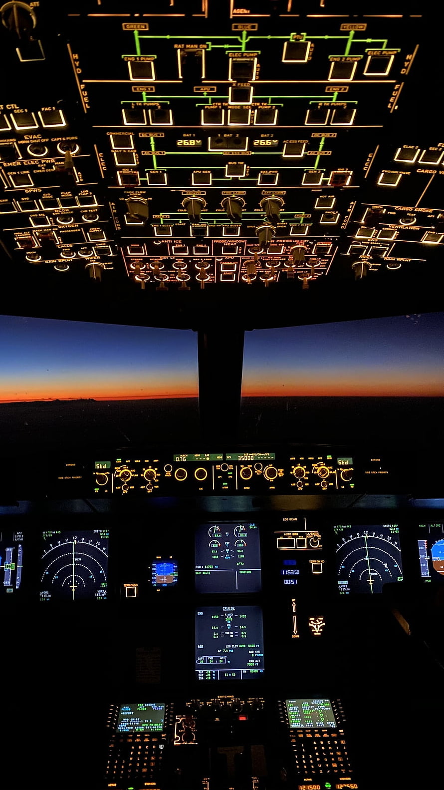 Boeing 747 Cockpit Interior at Sunset with Glowing Instrument Panels and Flight Displays HD phone wallpaper