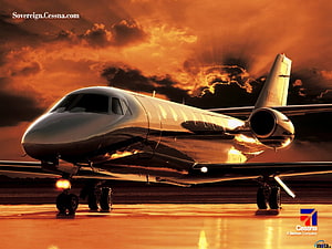Cessna Citation Private Jet on Runway at Sunset with Dramatic Orange Sky HD wallpaper