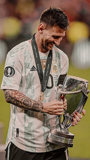 Lionel Messi Holding The Finalissima Trophy In Argentina National Team Kit HD phone wallpaper