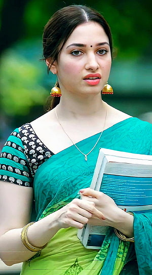 Tamanna Bhatia in a teal and green sari holding books with gold jewelry HD phone wallpaper