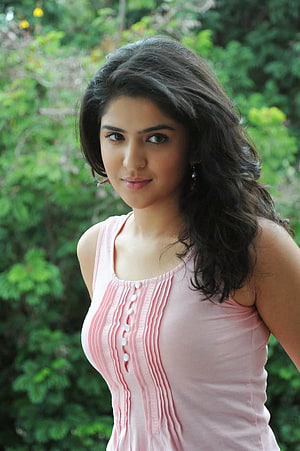 Portrait of a woman with long dark hair wearing a pink sleeveless top in a garden, South Indian Actress Hot Pic Gallery HD phone wallpaper