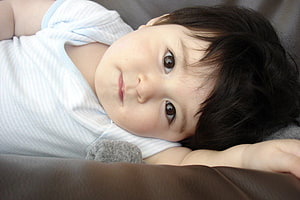 Adorable Asian Baby Boy Lying Down In White Striped Shirt HD wallpaper