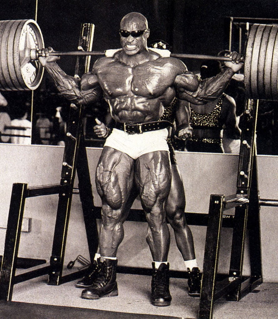 Ronnie Coleman performing a heavy barbell squat in a vintage black and white bodybuilding photo HD phone wallpaper