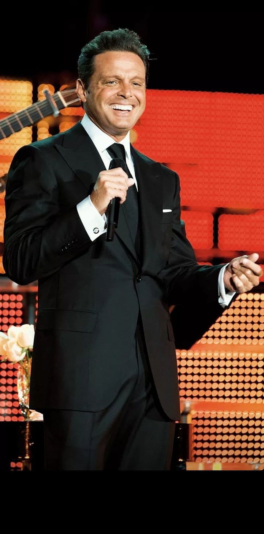 Luis Miguel performing on stage in a black suit holding a microphone HD phone wallpaper