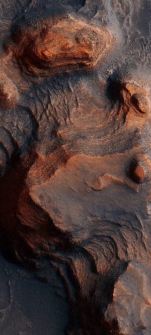 Aerial View of Rugged Desert Terrain with Rust and Dark Earth Tones HD phone wallpaper