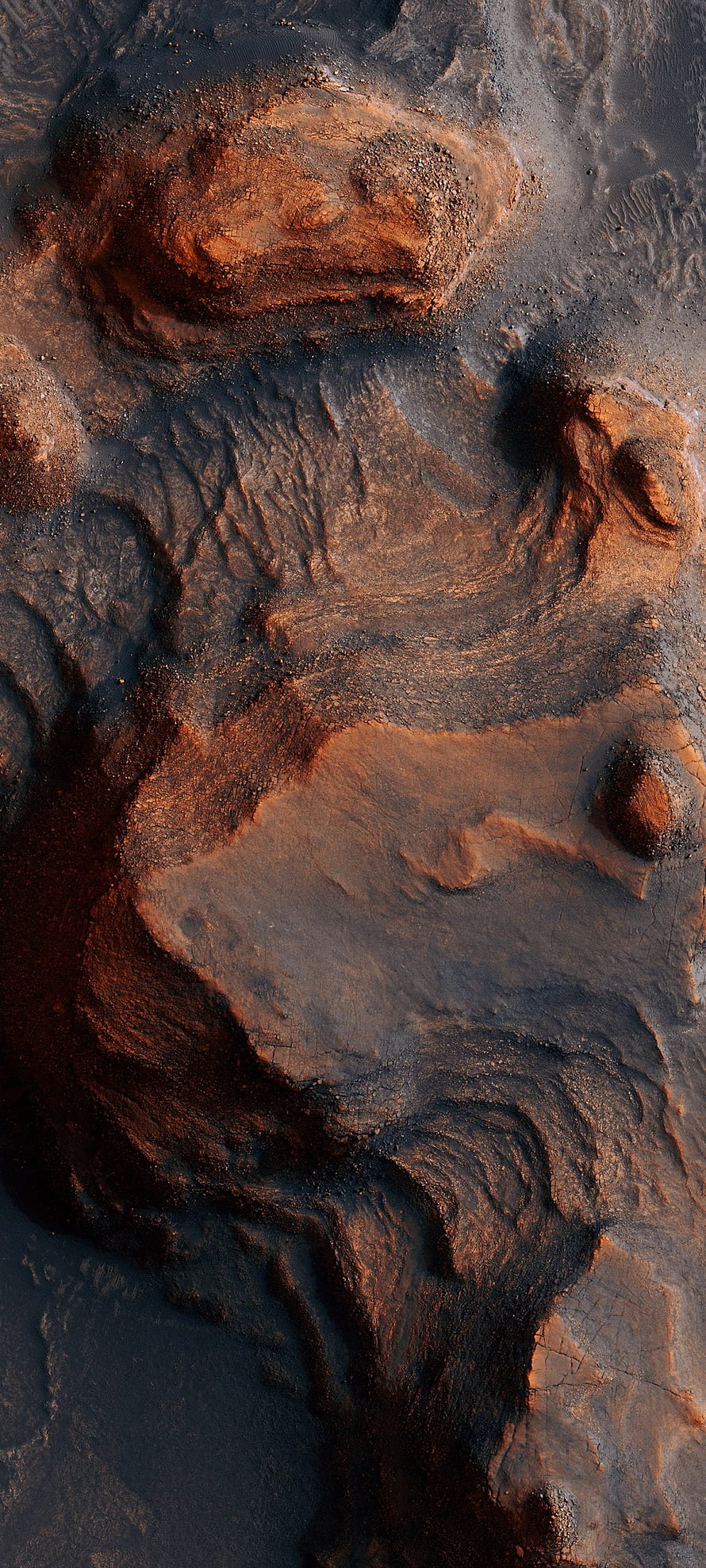 Aerial View of Rugged Desert Terrain with Rust and Dark Earth Tones HD phone wallpaper
