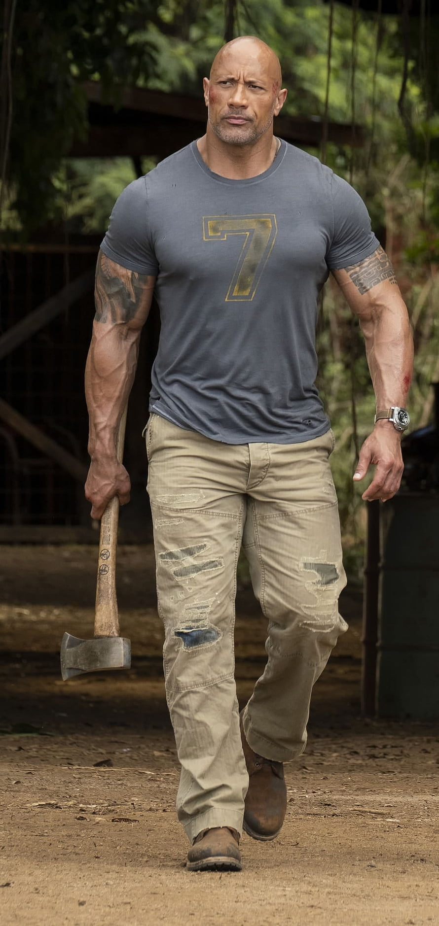 Dwayne Johnson Walking with Axe in Jungle Setting HD phone wallpaper